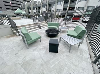 Outdoor patio seating area with green cushioned chairs